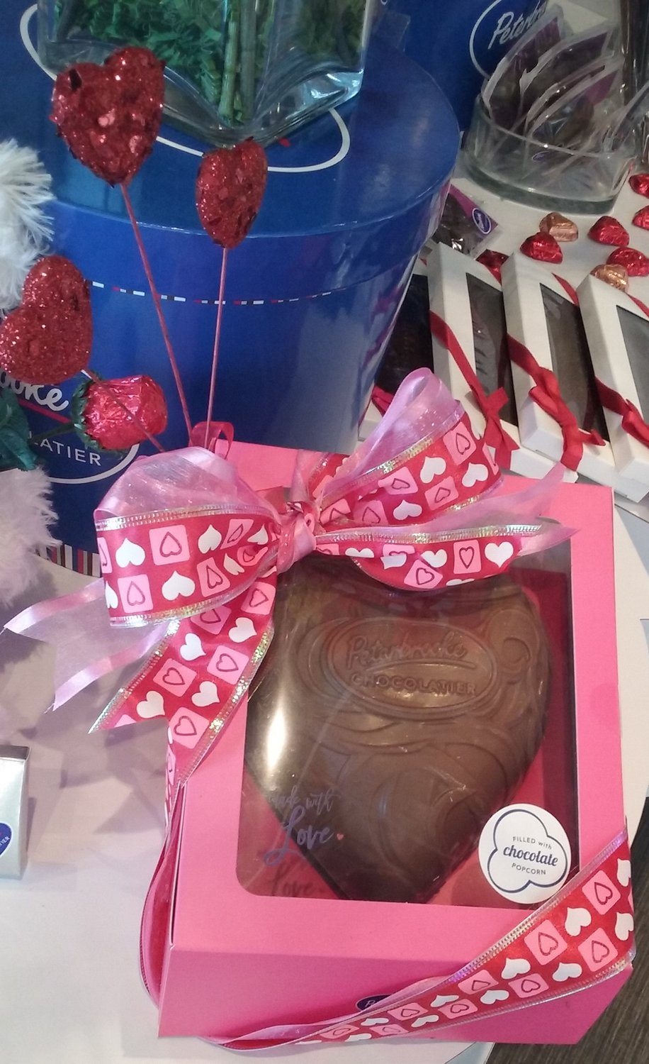 Large chocolate hearts are filled with one of Peterbrooke Chocolatier’s most popular items: chocolate-dipped popcorn.